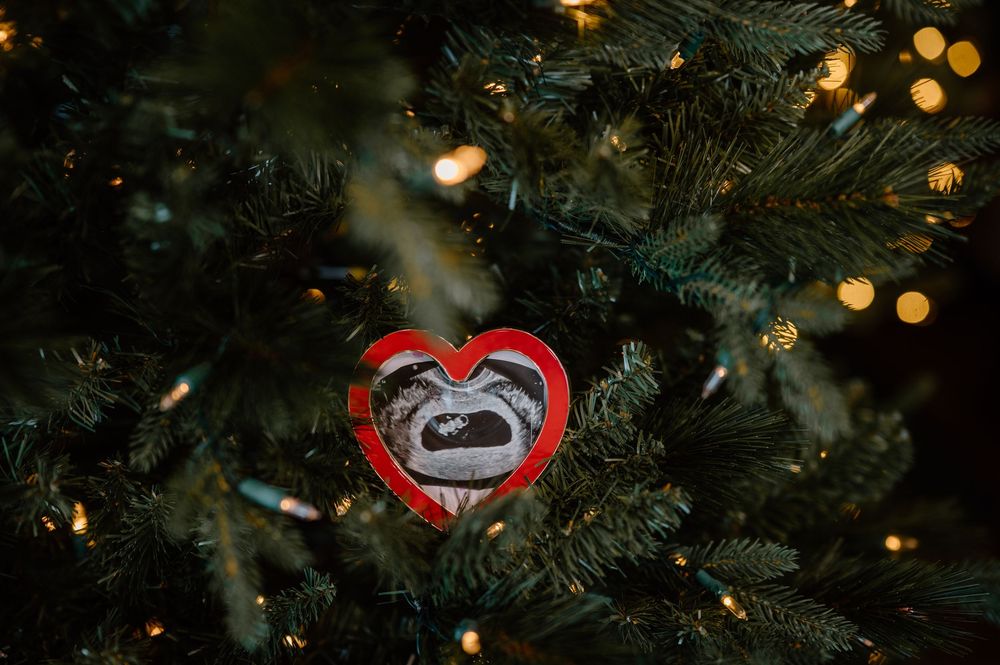 Close up view of Christmas tree branches with twinkling lights creating a festive holiday atmosphere.