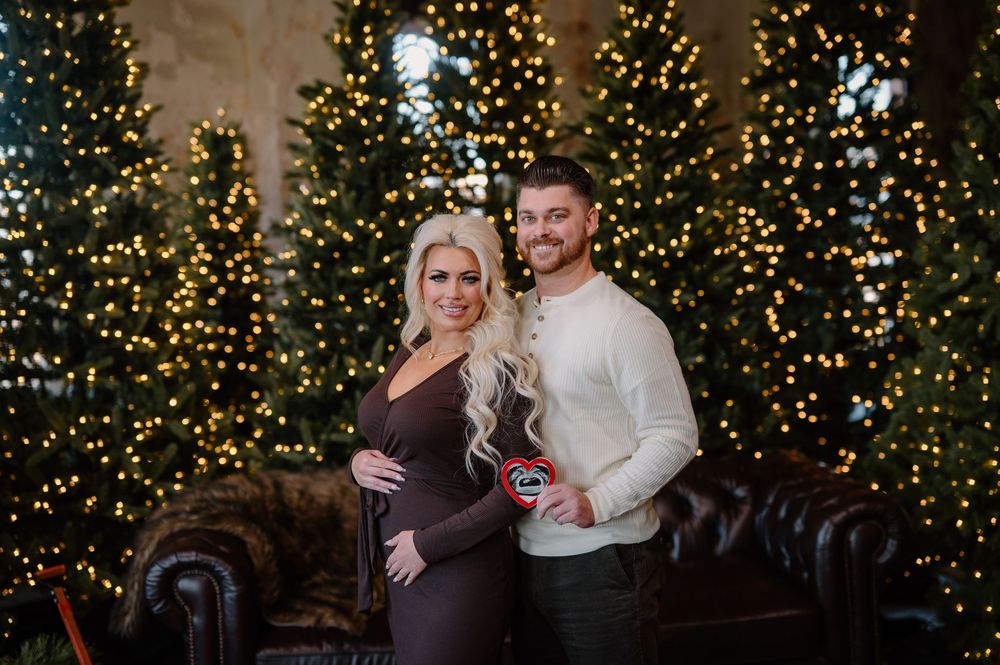 Festive Christmas portraits captured in front of illuminated trees with twinkling lights creating a warm holiday atmosphere.