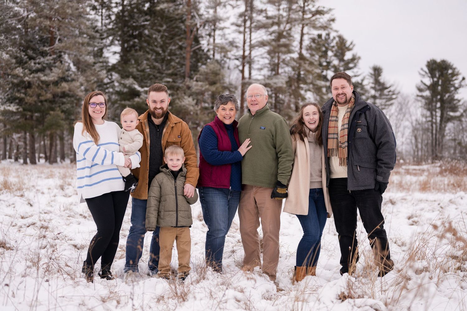 Group photo sequence showing family members walking and posing together in snowy landscape.
