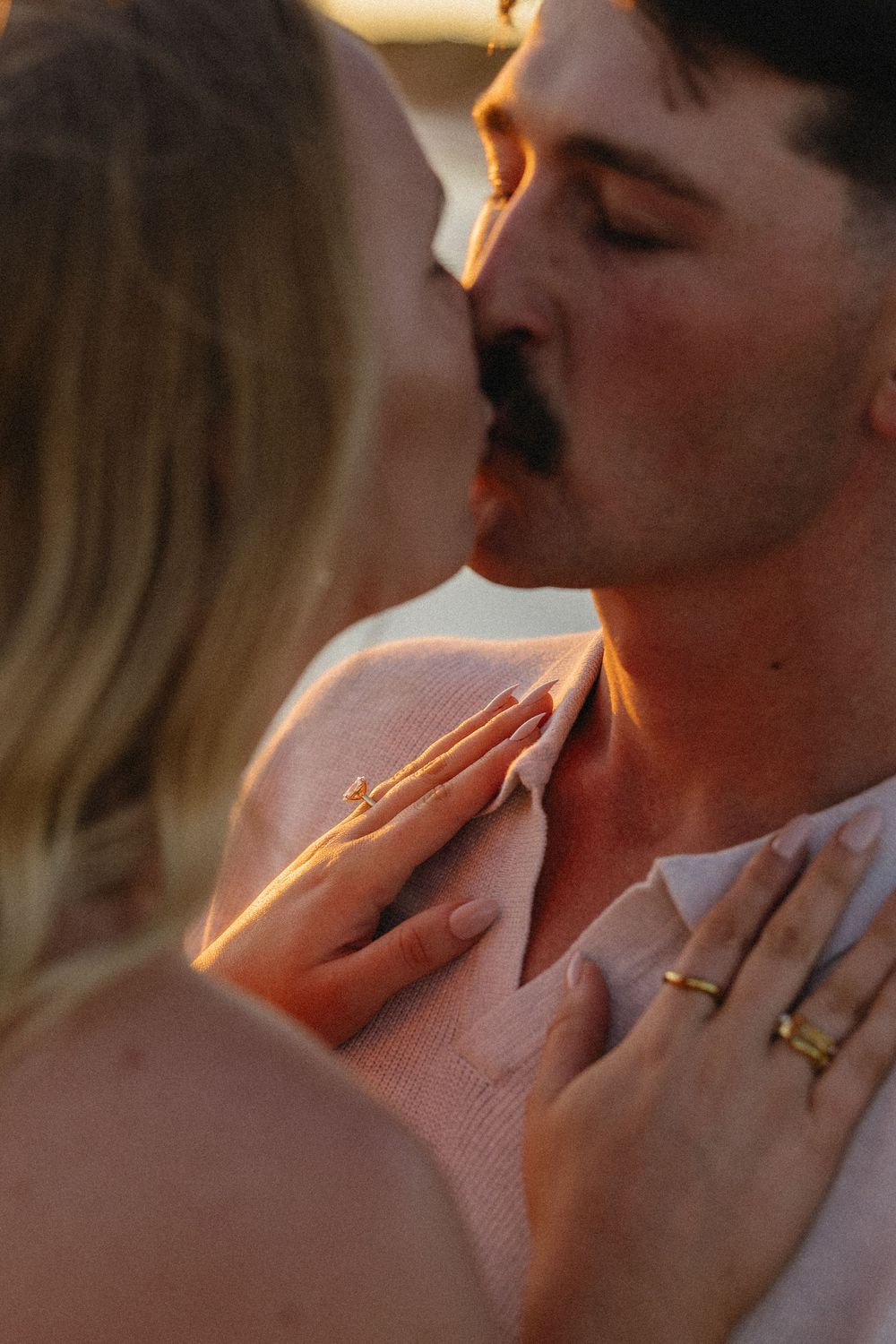 Close up series of romantic couple embracing and kissing in warm sunlit setting.