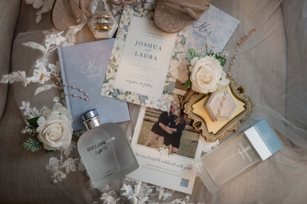 Wedding stationery and decor in soft pastel colors with roses and delicate paper elements arranged on a light surface.