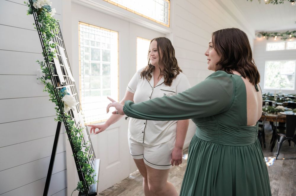 A group wearing coordinated sage green attire gathers in a sunlit room with white walls.