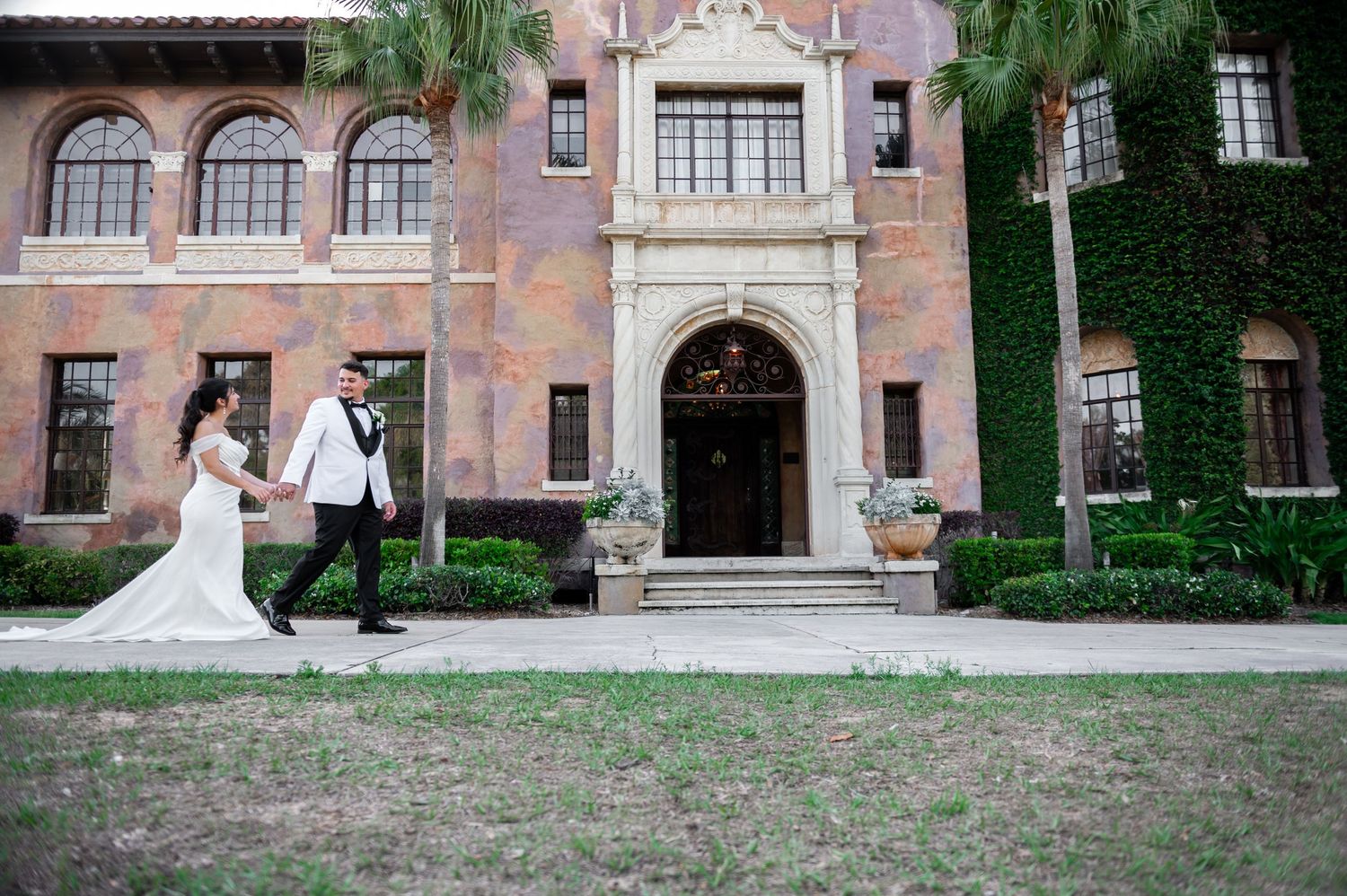 Florida destination wedding photographers captured the bride and groom in front of the Howie Mansion, a beautiful luxury wedding venue.