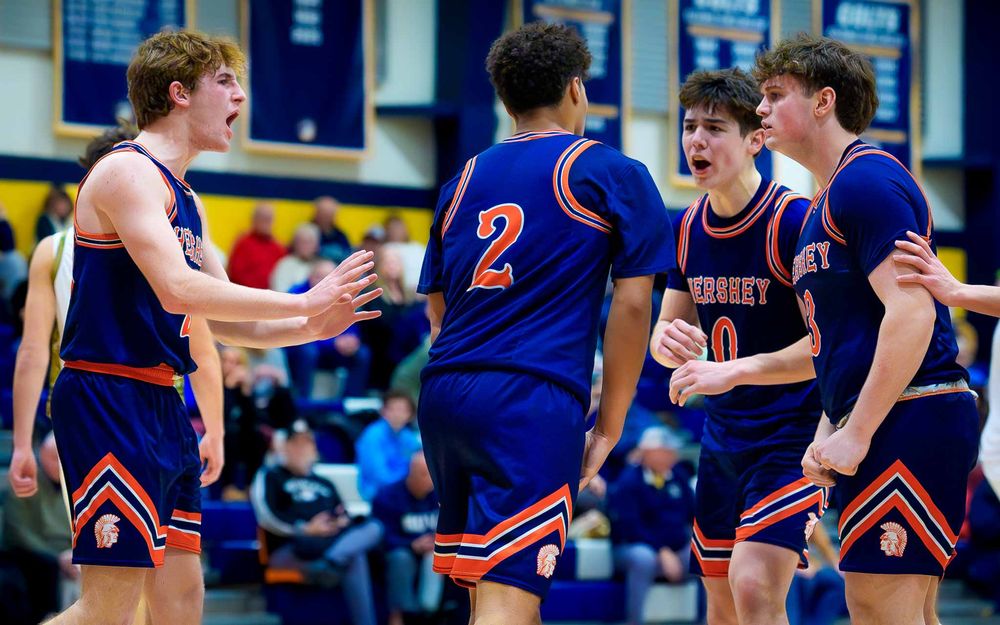 Cam Sweeney celebrates reaching the all-time points milestone with intensity & teammate by SportsFox Photography, Hershey PA.