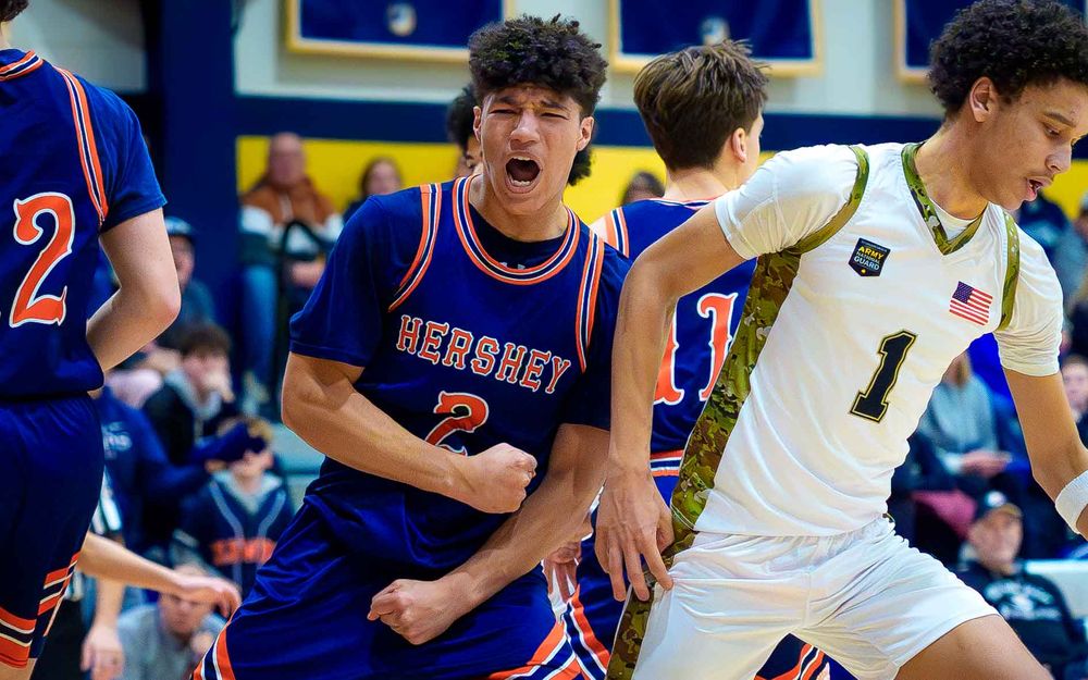Cam Sweeney celebrates reaching the all-time points milestone with intensity & teammate by SportsFox Photography, Hershey PA.