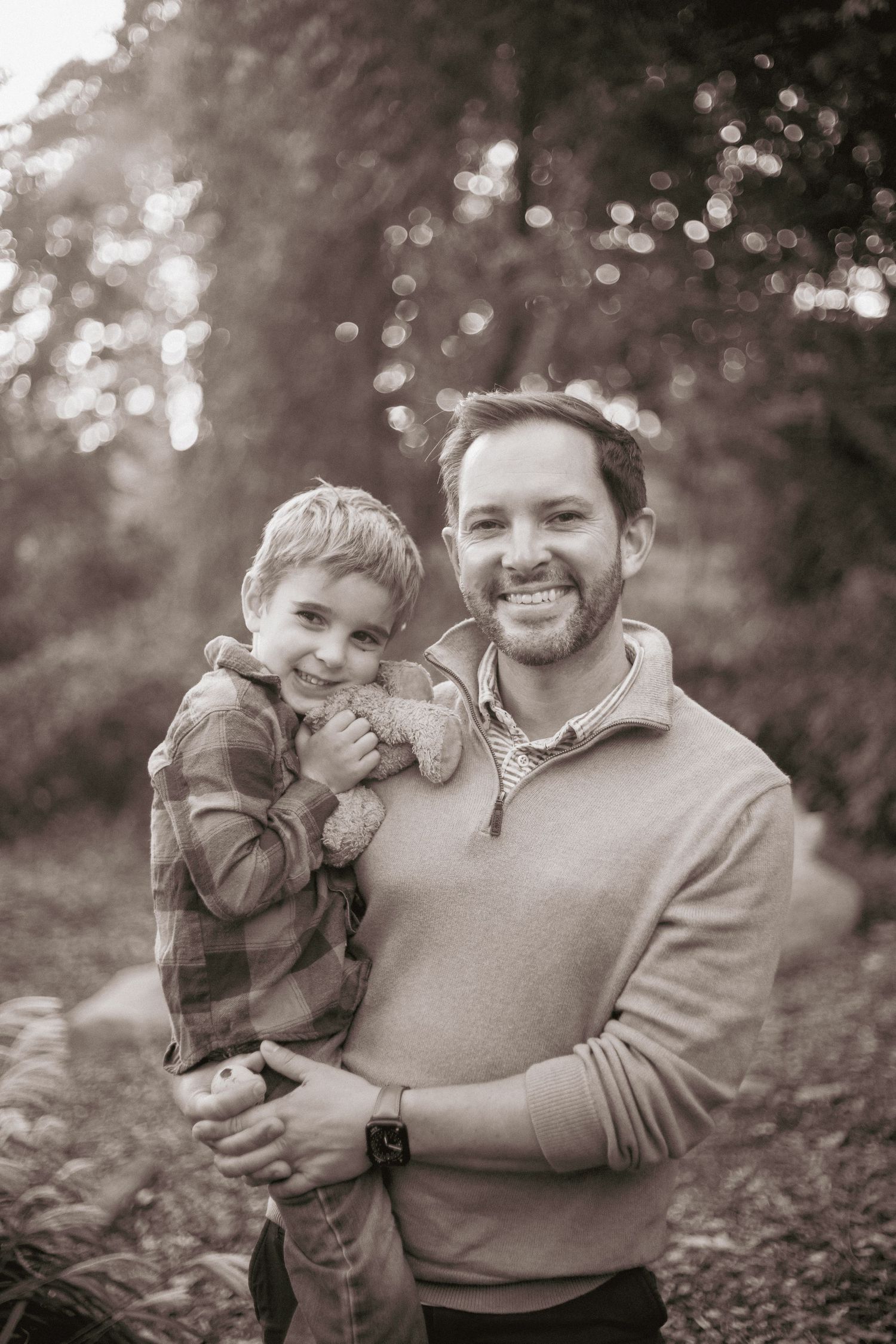 A heartwarming black and white photo series showing tender moments between a parent and child in nature.