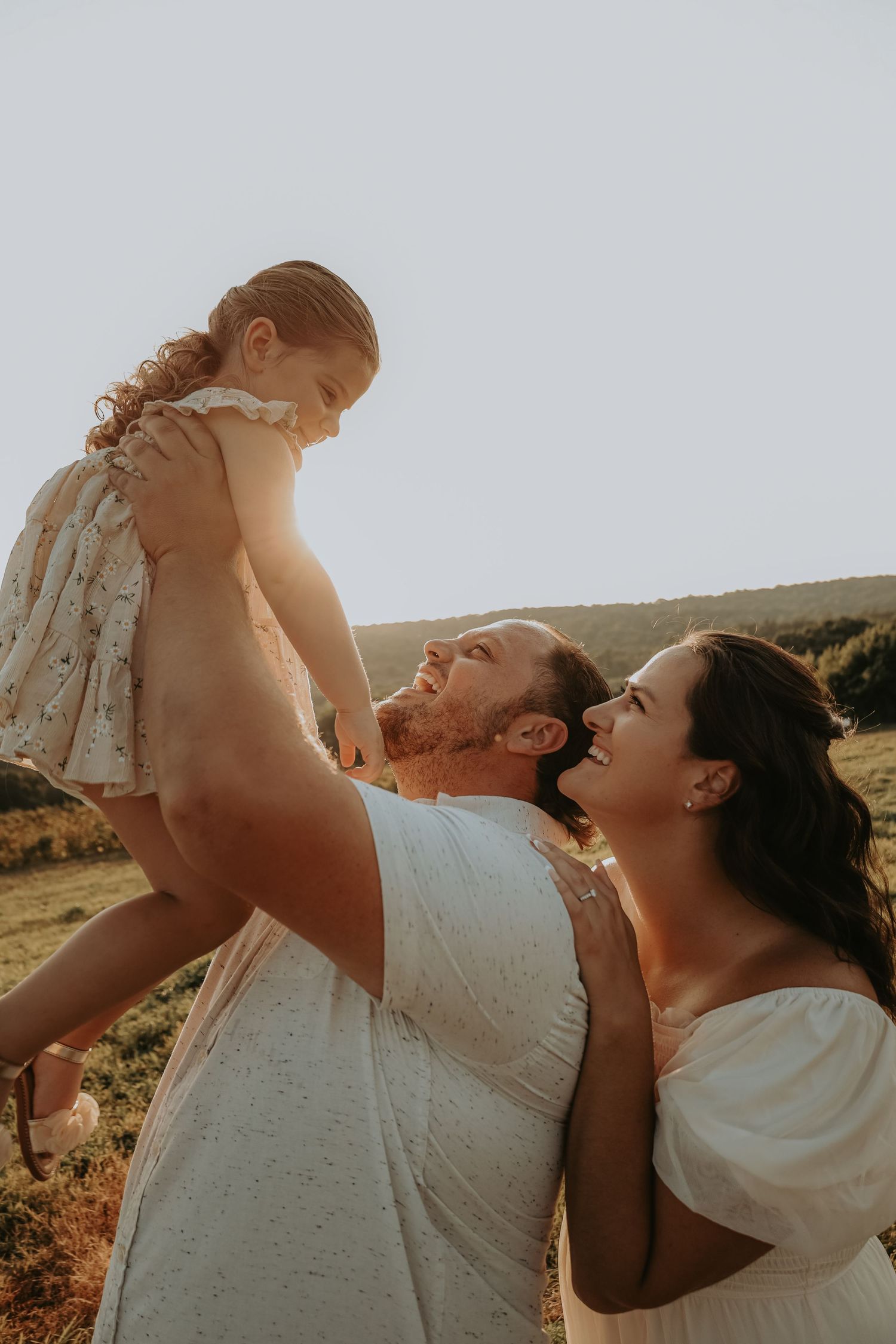 A loving family moment captured in a series of warm sunset photos showing joyful interactions outdoors.