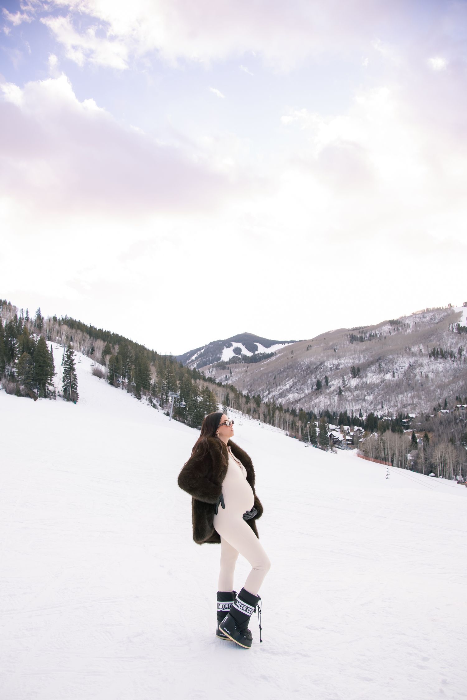 Beautiful luxe and stylish maternity photo session with snowy mountains and sunset in Vail Colorado