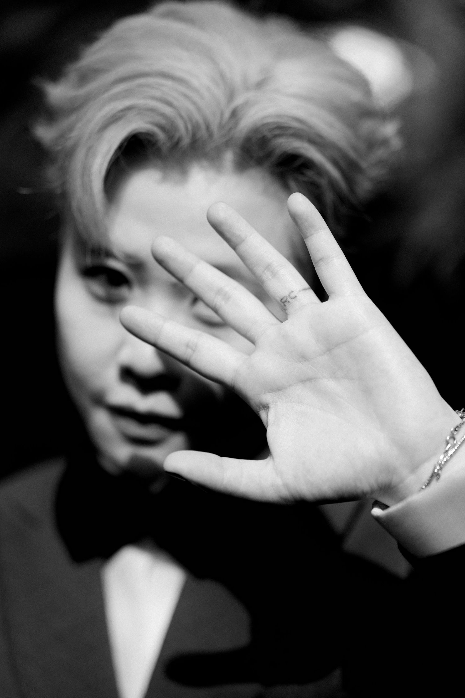 Black and white artistic sequence showing hands covering parts of a face in an expressive portrait series.