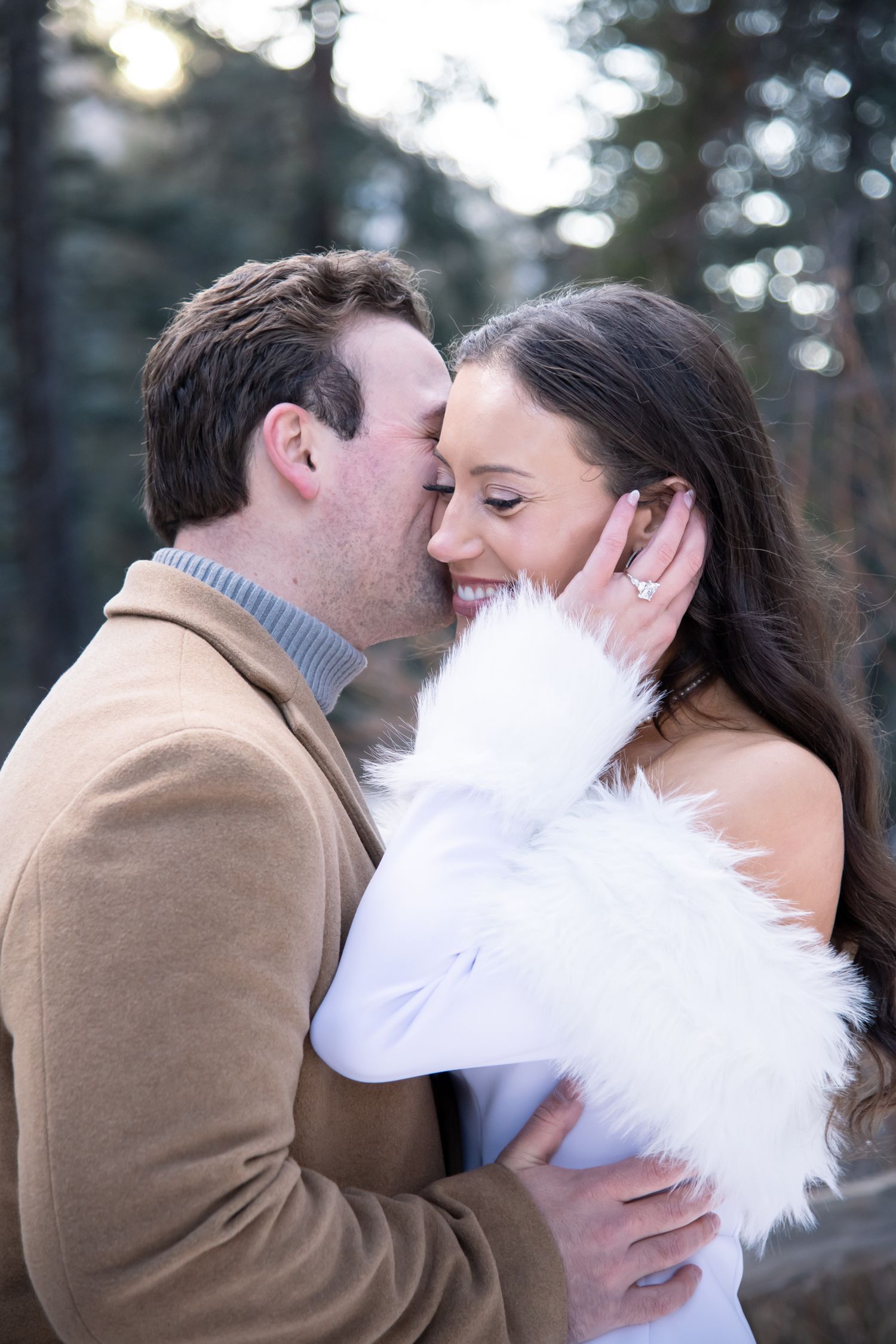 A romantic couple shares an intimate moment during their winter engagement photos in Vail Colorado.