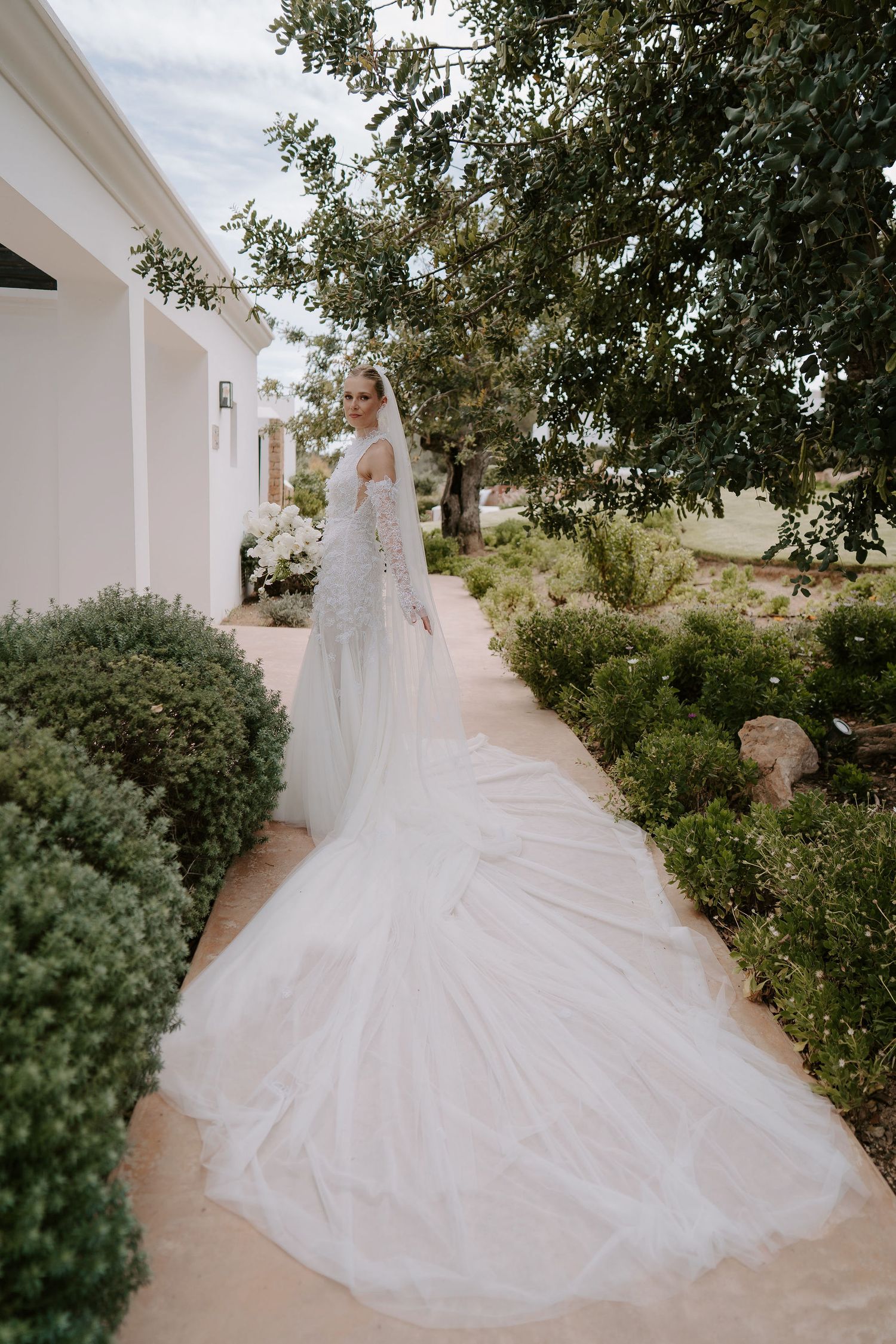 bride adjusting veil wearing Emma Beaumont dress at casa maca ibiza