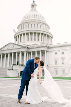 Romantic wedding couple shares intimate dips and kisses in front of the majestic US Capitol building.