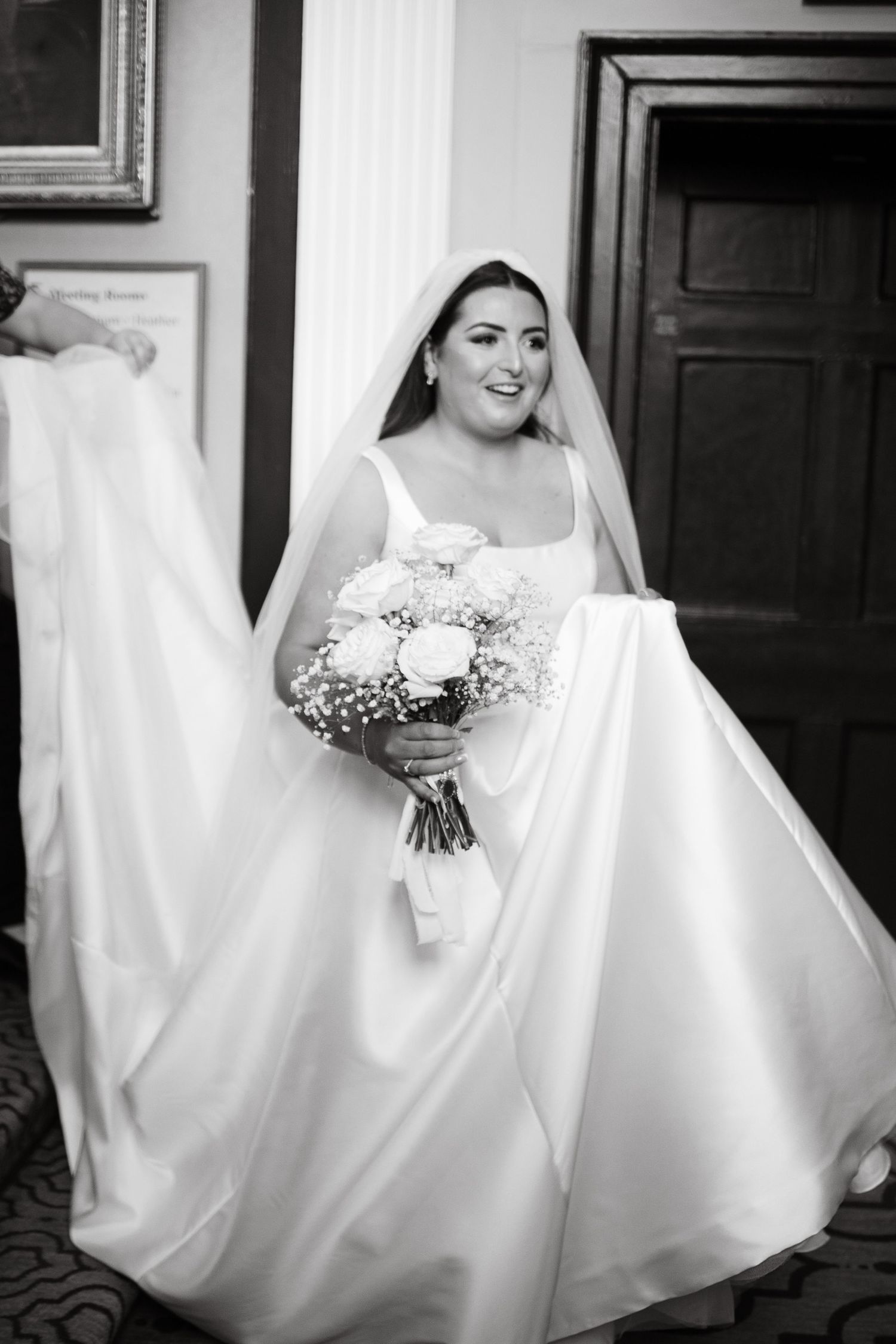 Classic bridal portrait featuring a flowing white wedding dress and bouquet.