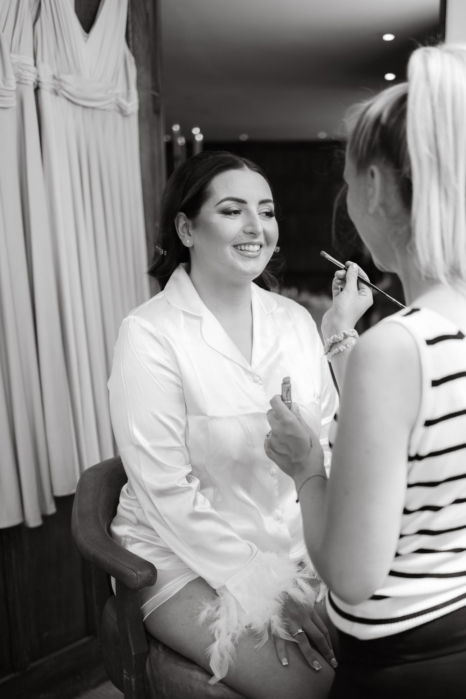Getting ready moments captured in black and white as wedding preparations begin.