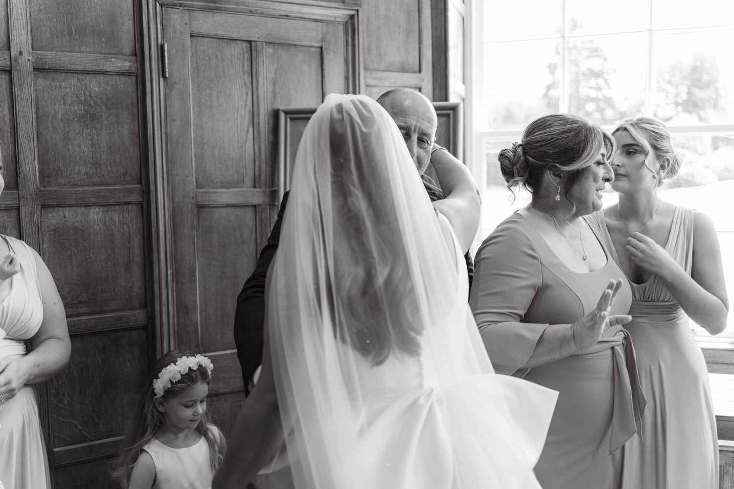 Candid black and white photos capturing pre-wedding moments in an elegant interior setting.