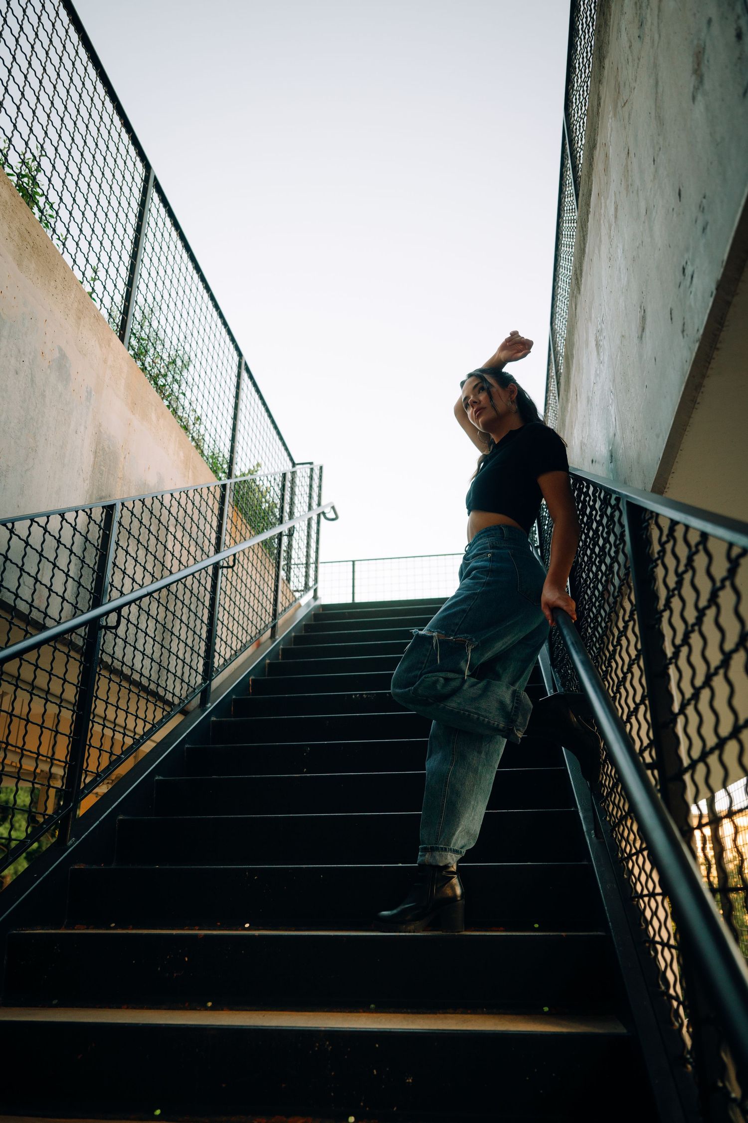 Sequence showing movement up concrete stairs with metal railings in an urban setting.