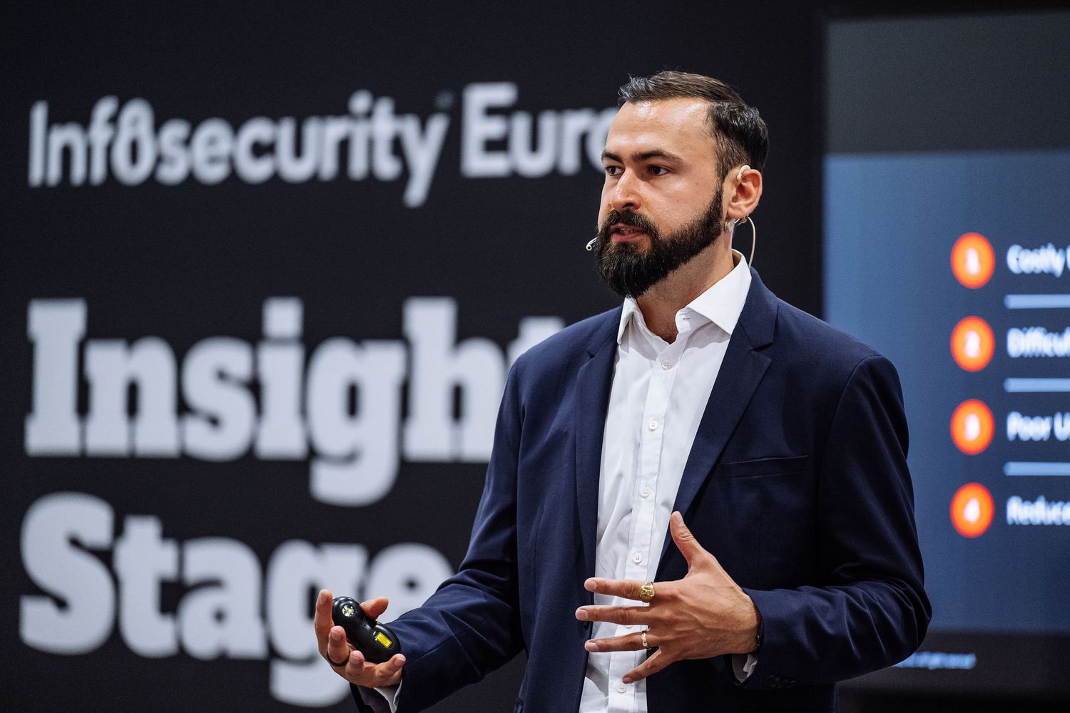 Conference speakers presenting on stage at Infosecurity Europe event.
