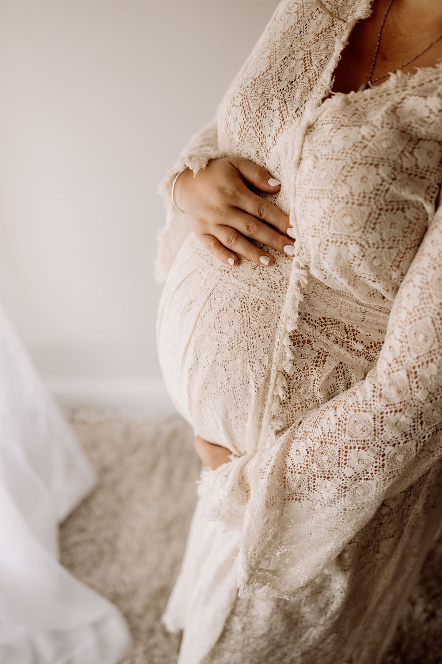 Close-up of vintage lace dress details with intricate patterns in soft natural light.