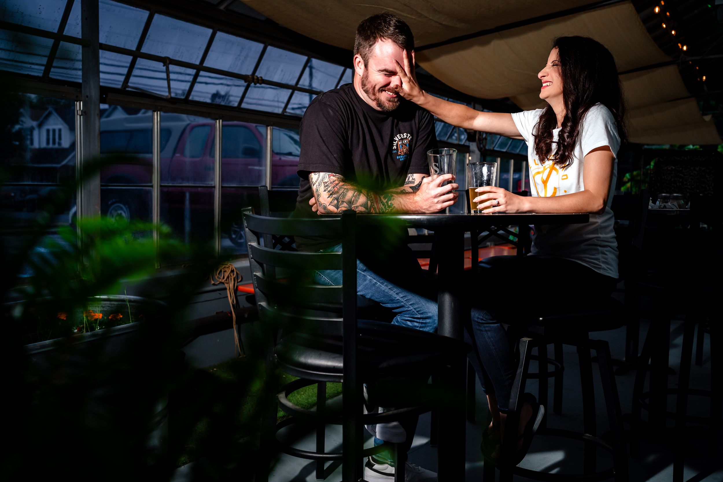 A romantic evening scene at an outdoor restaurant with ambient lighting and intimate seating.