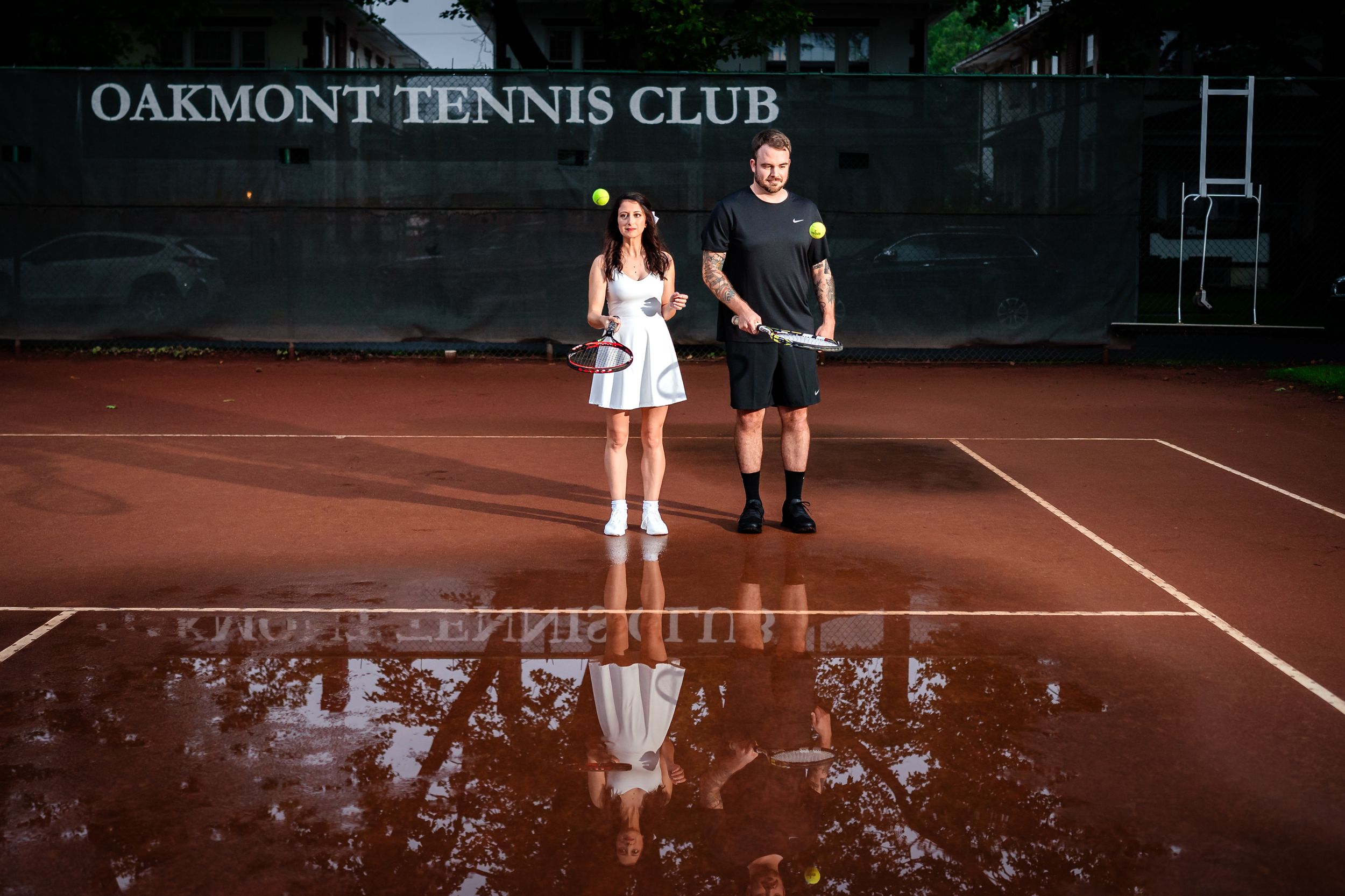 A romantic photoshoot at Oakmont Tennis Club with the court and signage visible in background.