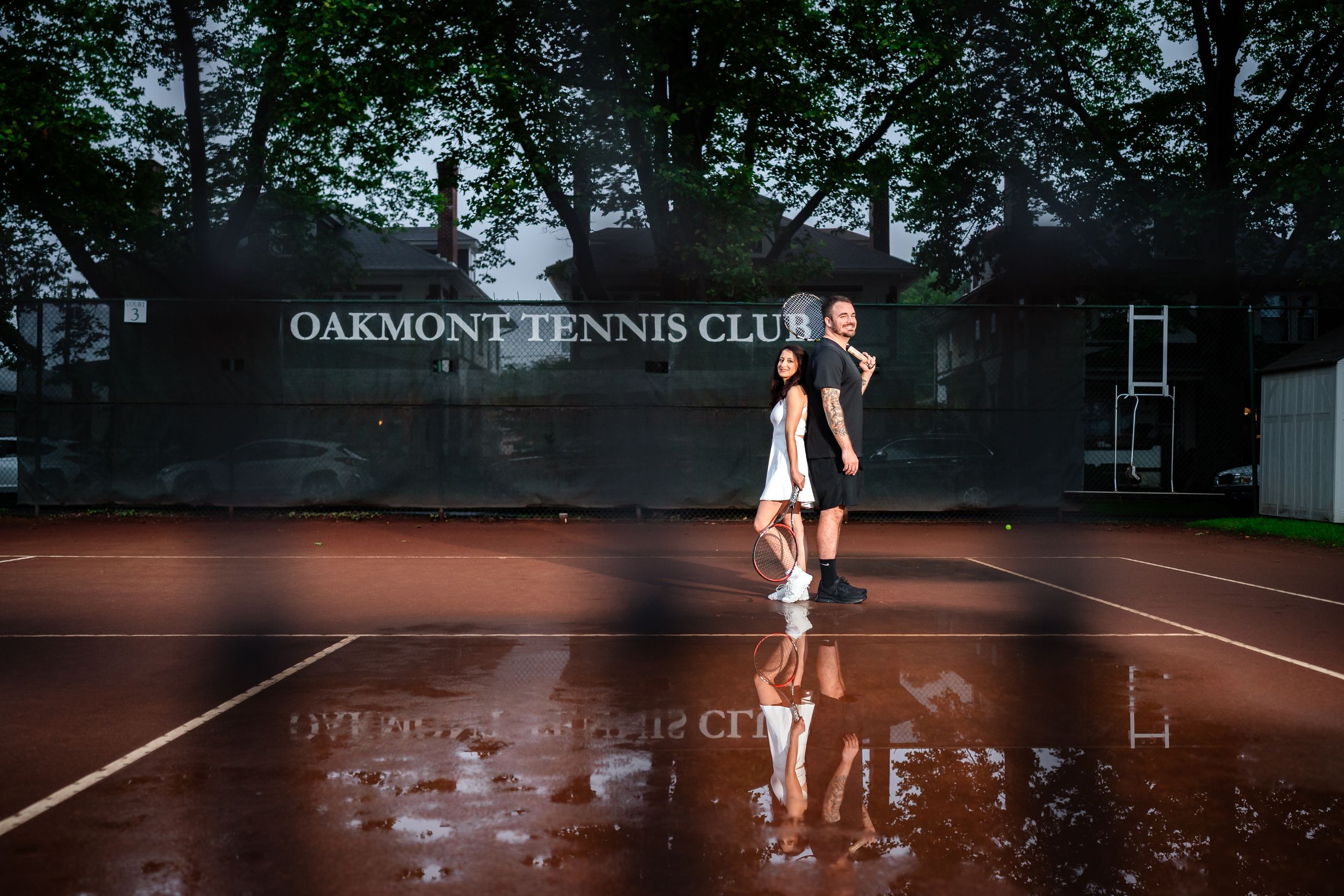A wide angle view of a tennis court engagement session at dusk.