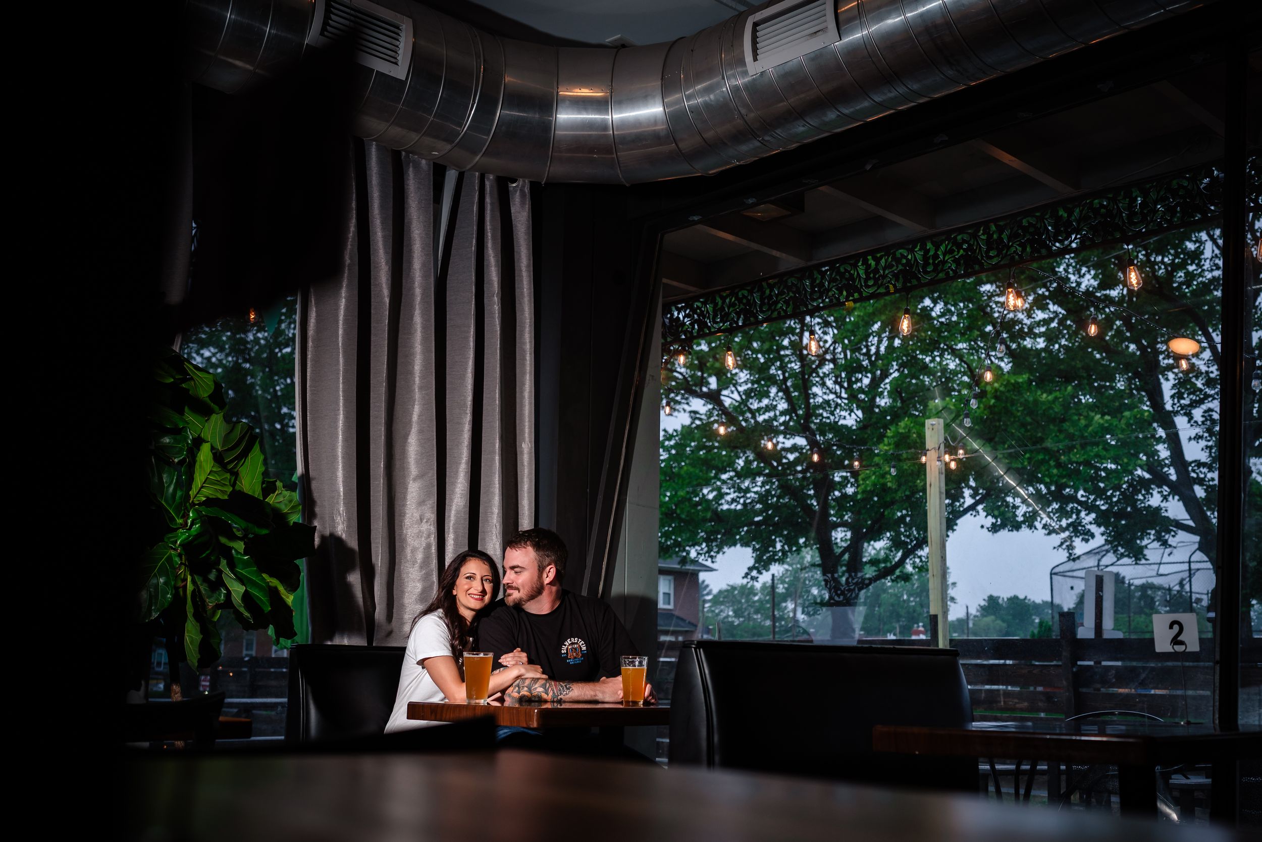 Moody evening scene through window of bar or restaurant interior.