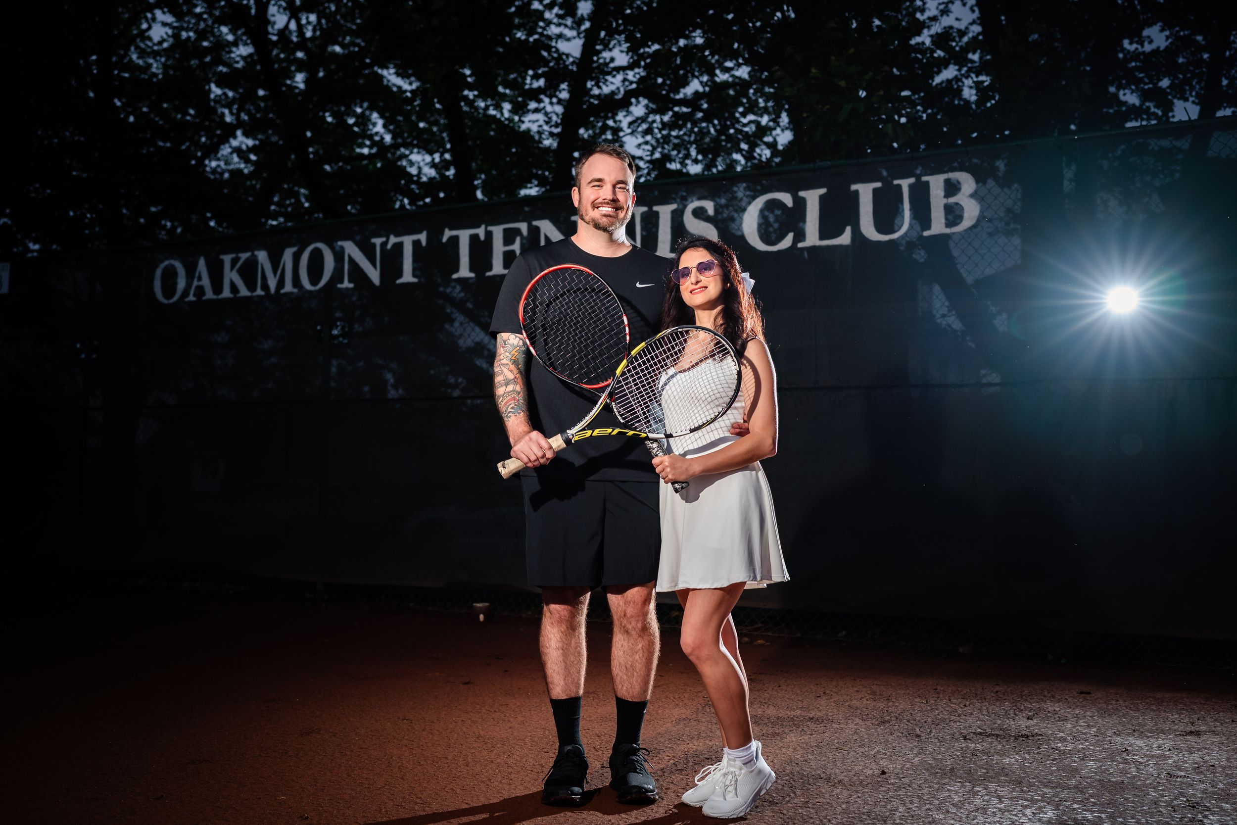 Night photography session at Oakmont Tennis Club with creative lighting effects.