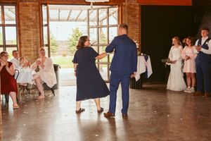 Wedding reception venue featuring exposed brick walls and natural lighting from large doorways.
