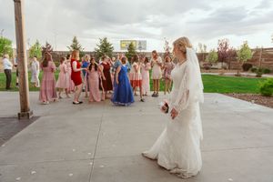 Wedding celebration under a covered outdoor pavilion with scenic countryside views in the background.