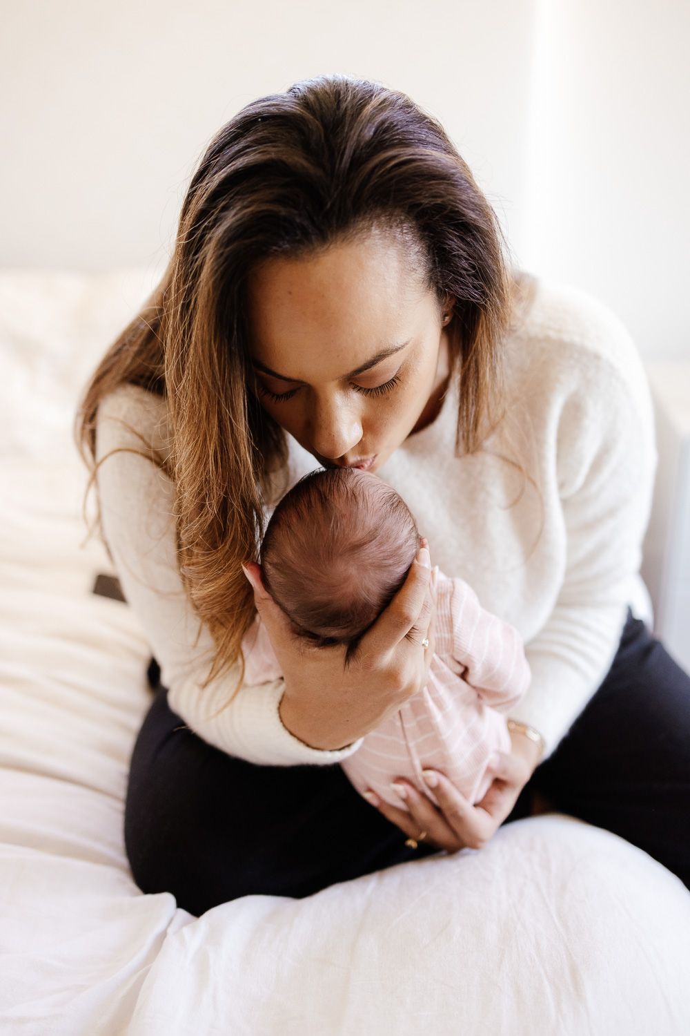 Mom kisses baby's head at their in-home baby photography session with Bay Area Newborn Photographer Cindy Tucey