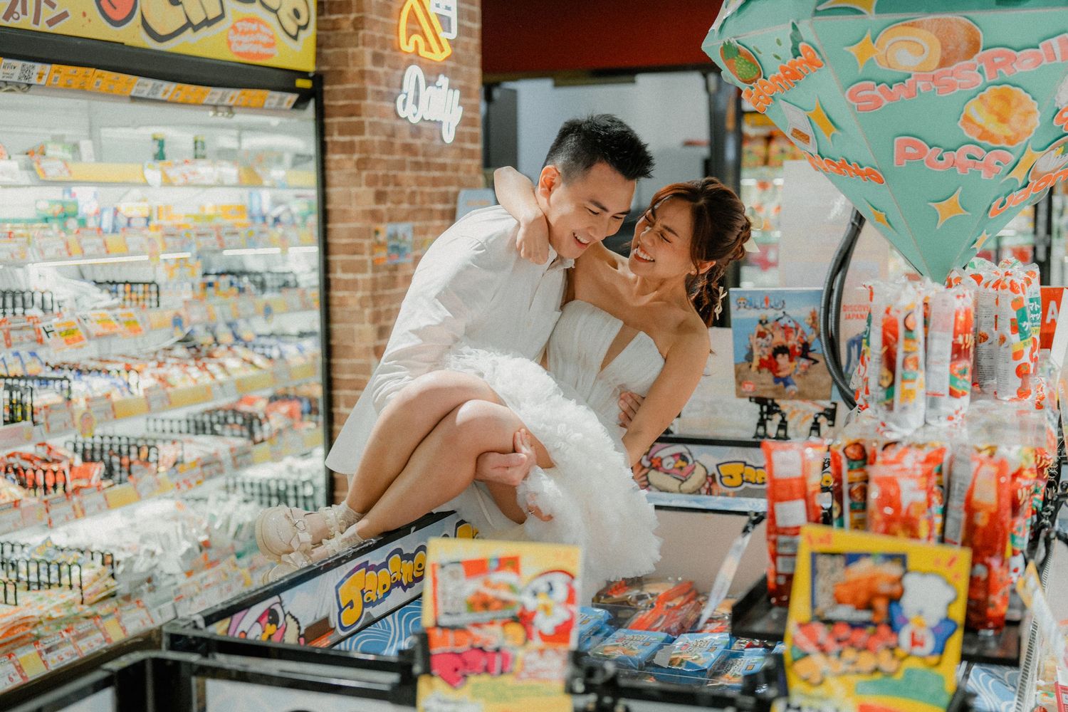 Playful couple shares a romantic moment while shopping among colorful displays in a retail store.