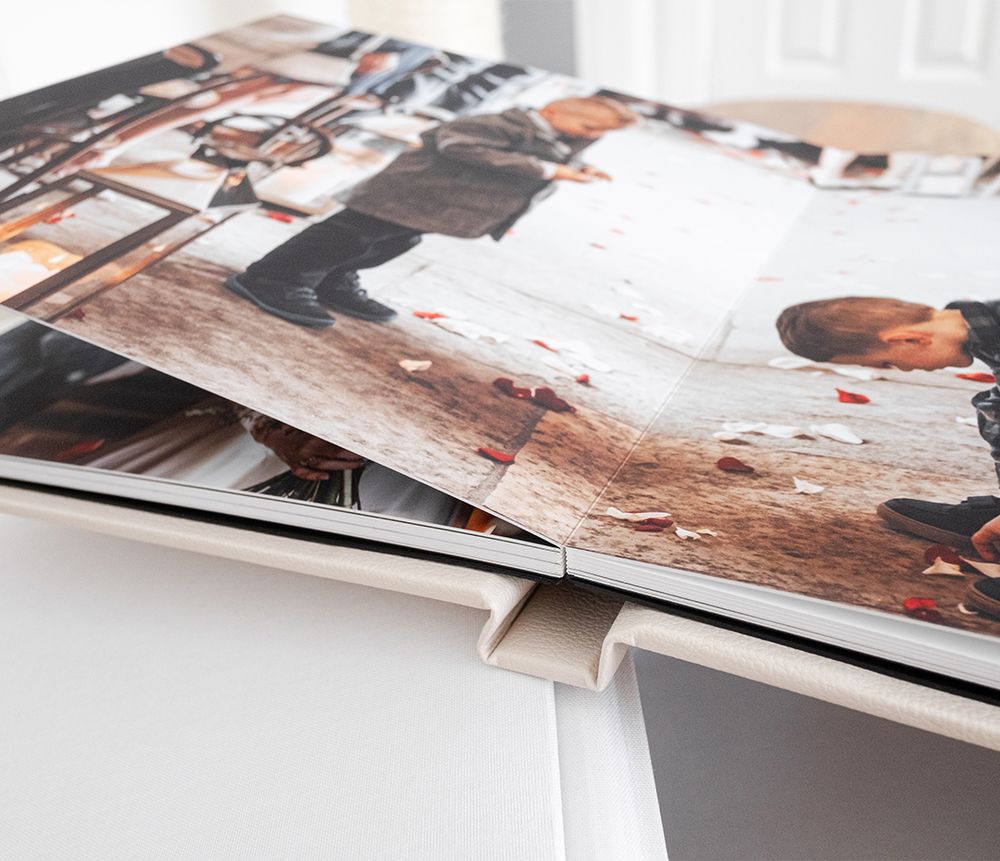 A stack of printed photographs with layered edges showing partial views of personal snapshots and memories.