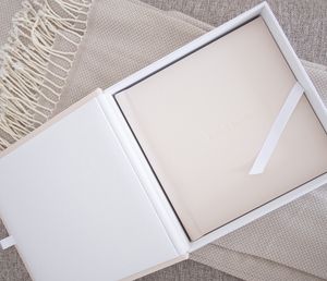 Time-lapse showing the progressive assembly of a minimalist white box frame on a beige textured surface.