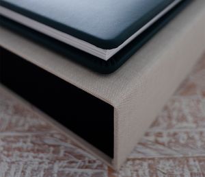 Laptop keyboard and trackpad shown from an angle on a white surface, casting subtle shadows.
