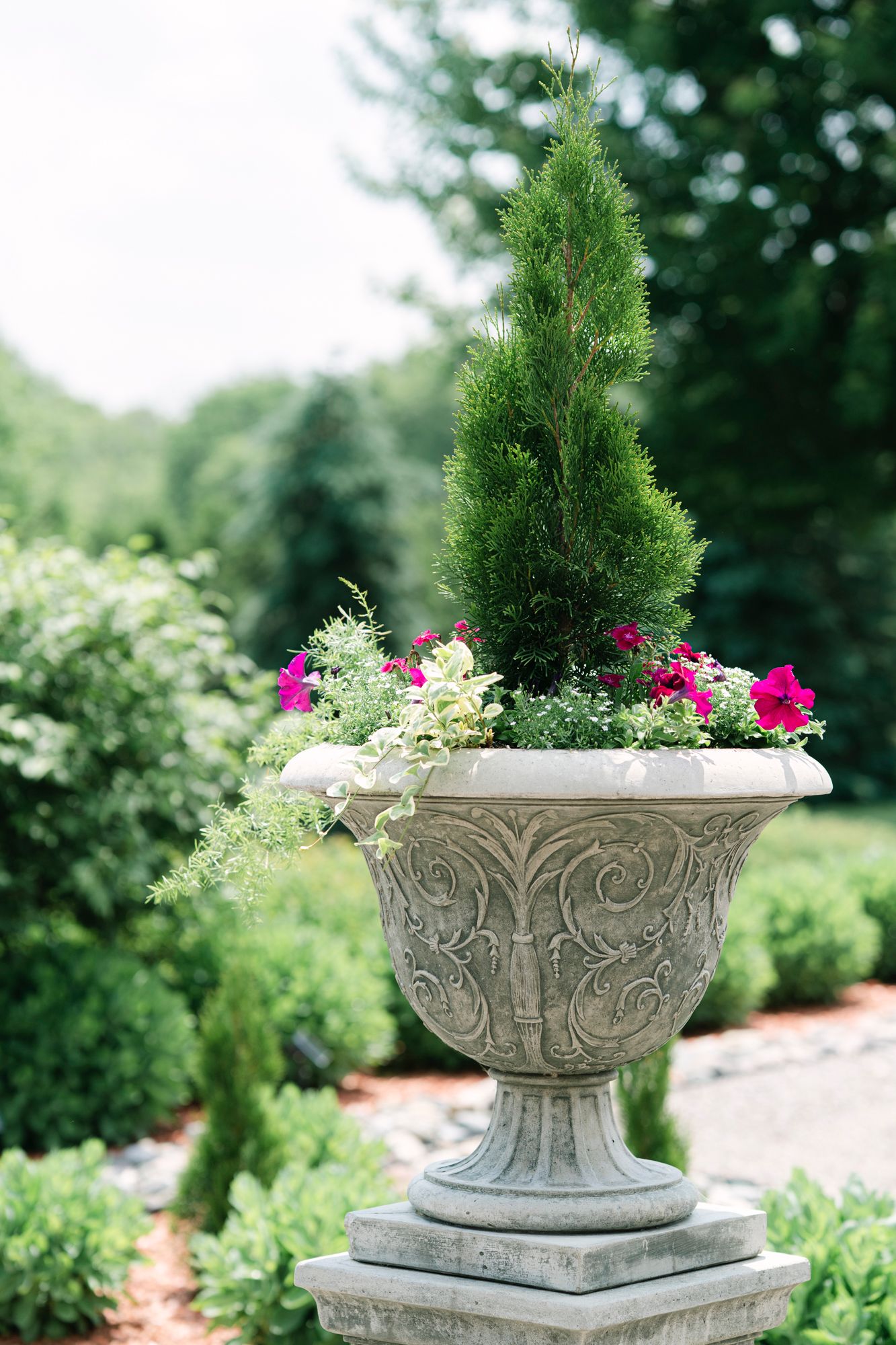 Detail shot of a classic urn-style vase overflowing with florals, sitting on the steps of Abby Wilfert’s childhood home in Independence, Min