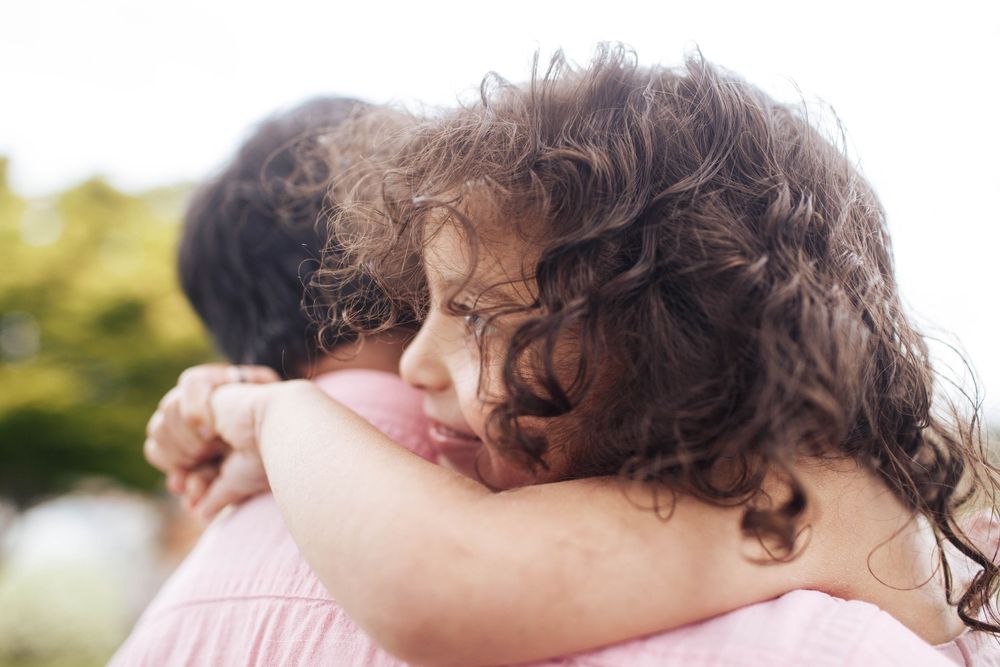 Everett family photographer: a daughter hugs her father in a close-up photograph