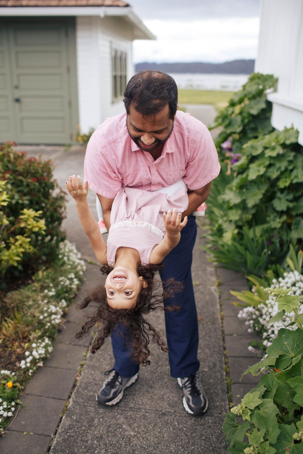 Mukilteo Family photographer: A father plays with his young daughter at a playful photography session at Mukilteo Lighthouse Park