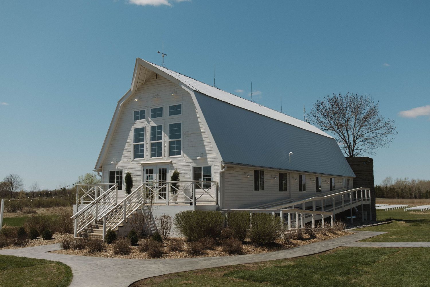 Exterior view of a white barn-style church wedding venue with classic architecture.