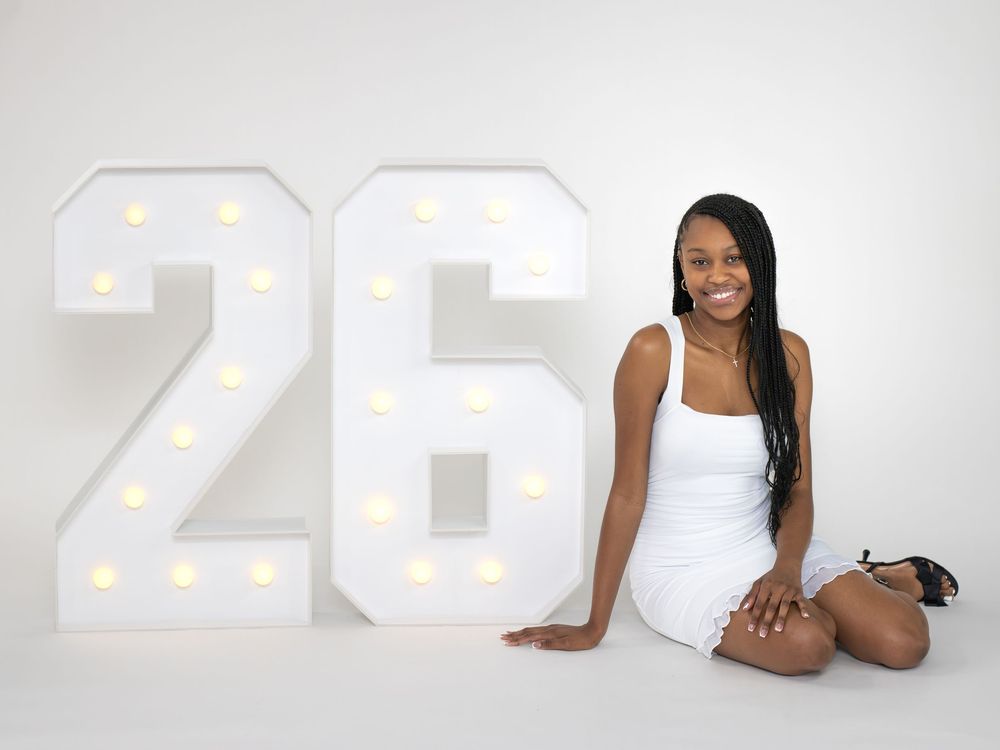 Studio graduation photos with illuminated numbers creating an elegant backdrop.