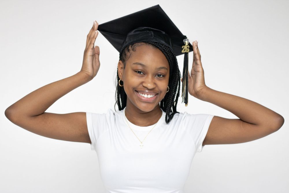 Playful graduation cap poses captured against a clean white studio background.