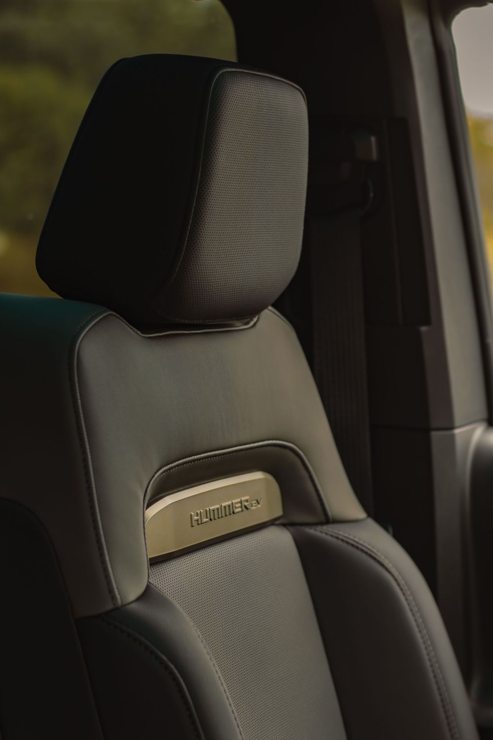 Gray leather car seats with headrests showing premium interior detailing and stitching.