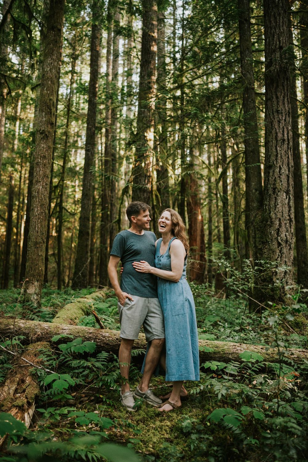 Adventurous couple engagement session photographer photoshoot of couple in Cumberland Forest Vancouver Island hugging and laughing