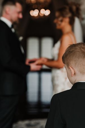 A series of intimate wedding photos showing candid moments between a couple and guests in warm lighting.