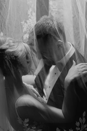 A romantic black and white photo sequence showing a couple sharing an intimate kiss.
