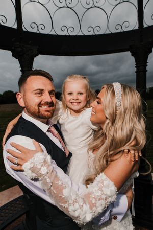 A happy family shares tender moments and kisses in a series of black and white wedding photos at Merrydale Manor