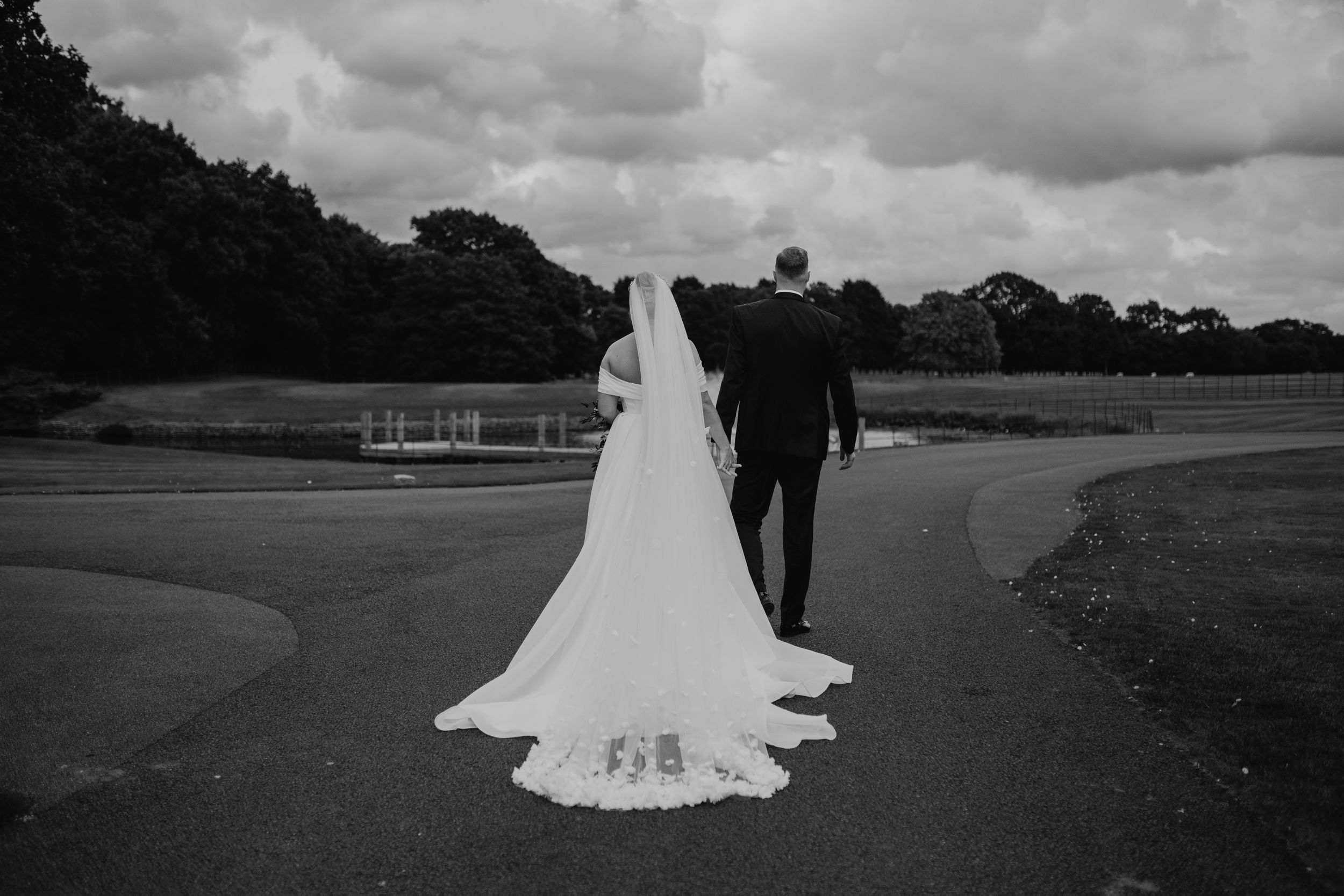 A collection of black and white wedding photographs showing silhouettes and flowing bridal gowns in outdoor settings at Merrydale Manor