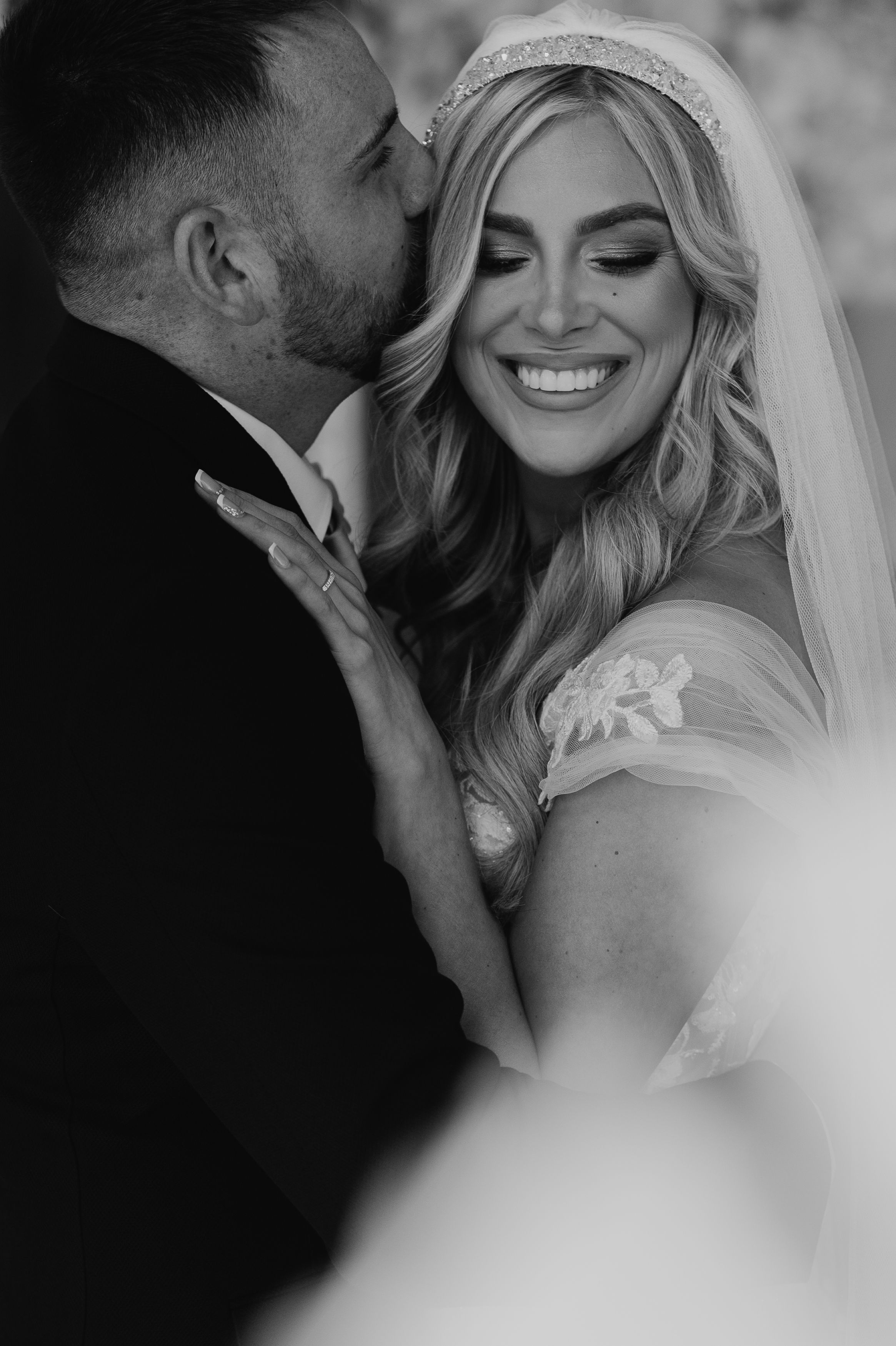 A romantic black and white wedding photo series showing intimate moments between a bride and groom in close-up shots at Merrydale Manor