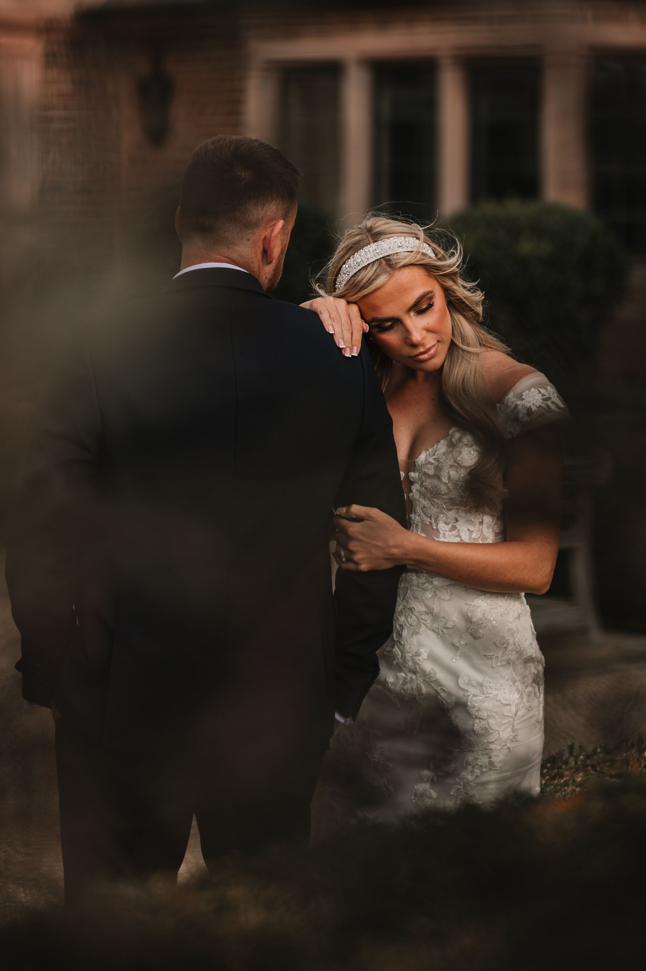 A romantic sequence of wedding photos showing a couple embracing in a dimly lit setting with soft, moody lighting at Merrydale Manor