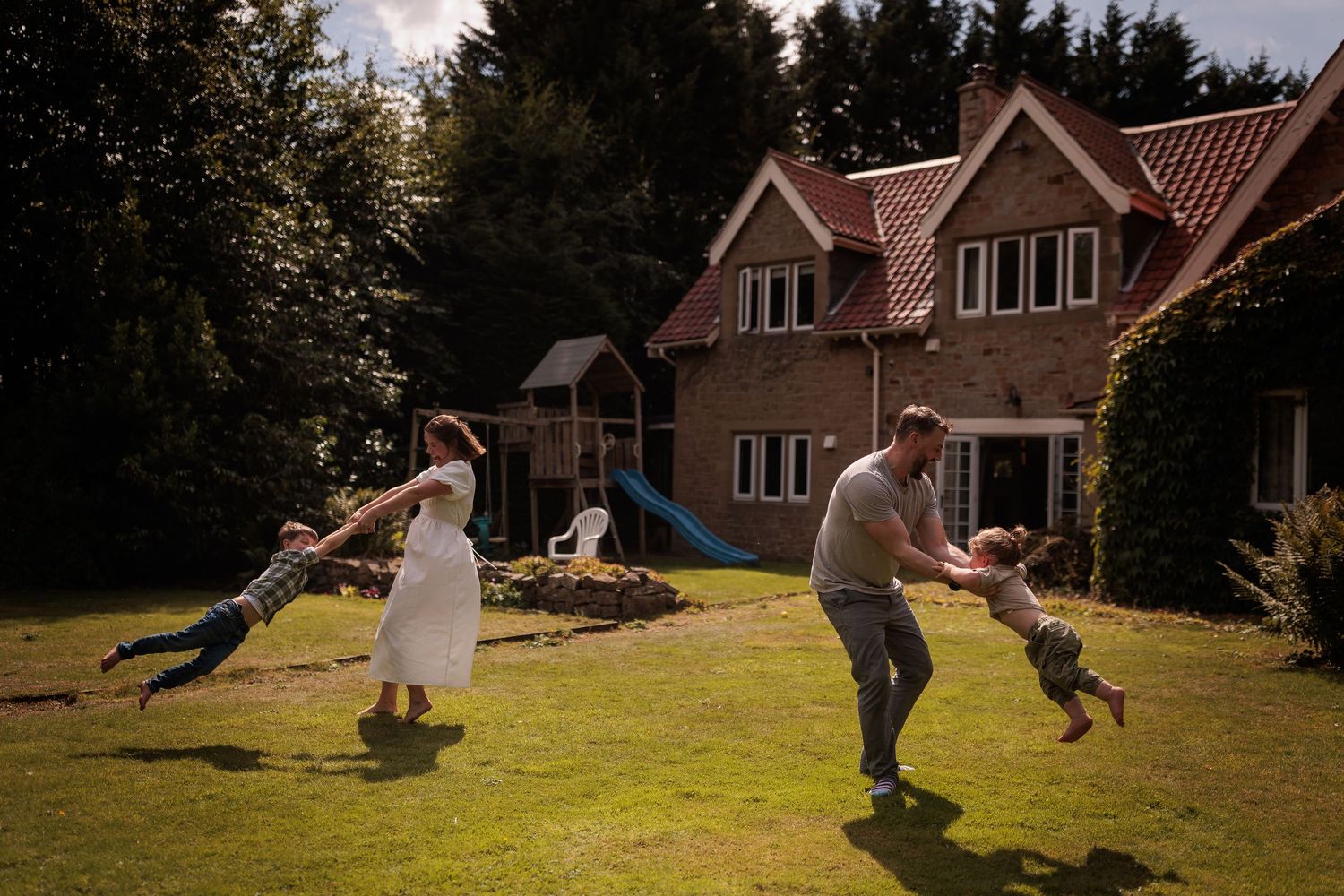 A sequence of playful moments captured in a backyard with figures running and playing on a sunny grassy lawn.