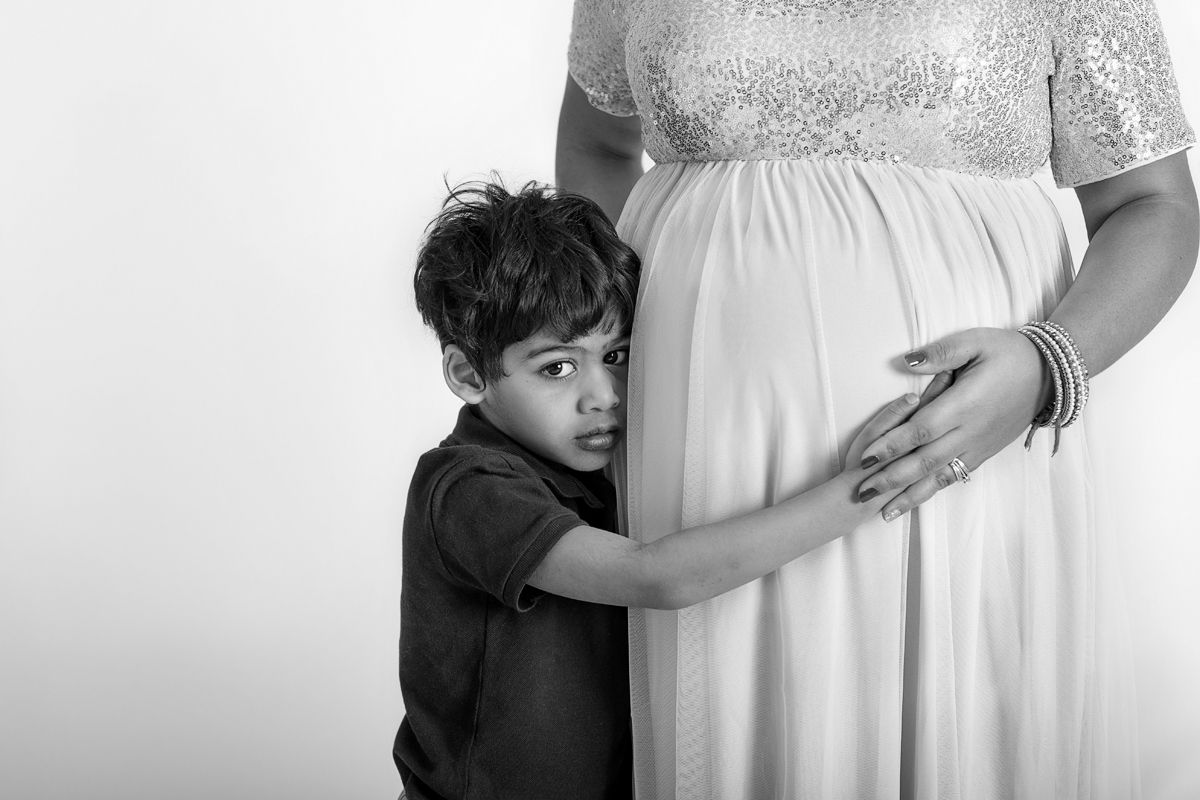 Black and white close up In studio Maternity photo with young son